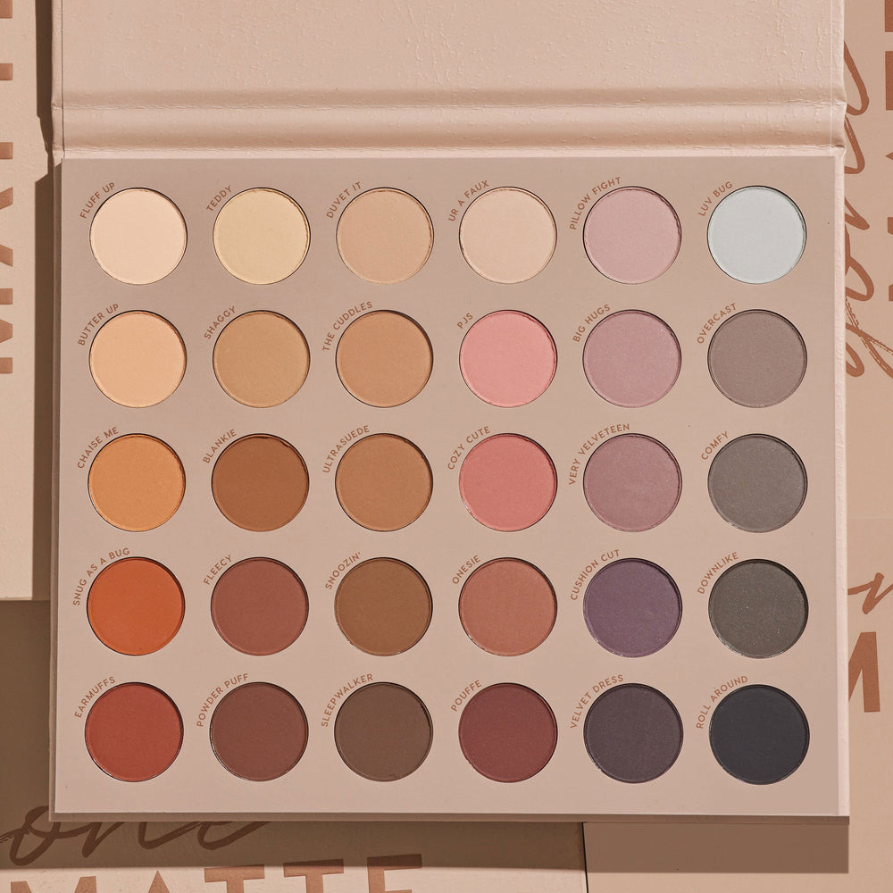 ColourPop Gone Matte Shadow Palette lies open, revealing 30 all-matte eyeshadow pans in 5 rows of 6 - neutral beiges, warm browns, soft pinks, mauves, taupes, and cool grays - set in a beige case on a tan backdrop under soft studio light.