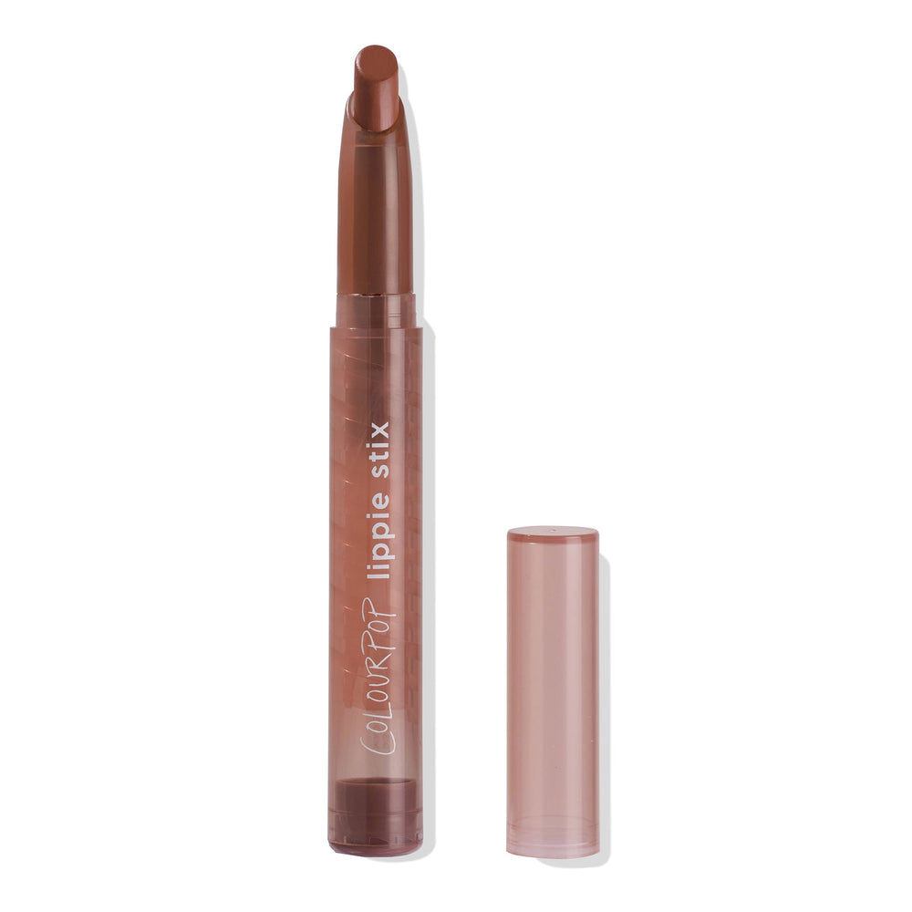 ColourPop Lippie Stix in Sassy standing uncapped, twist-up bullet raised to reveal a warm terracotta-brown lipstick, housed in a mauve tube with the clear cap set beside it on a clean white background.