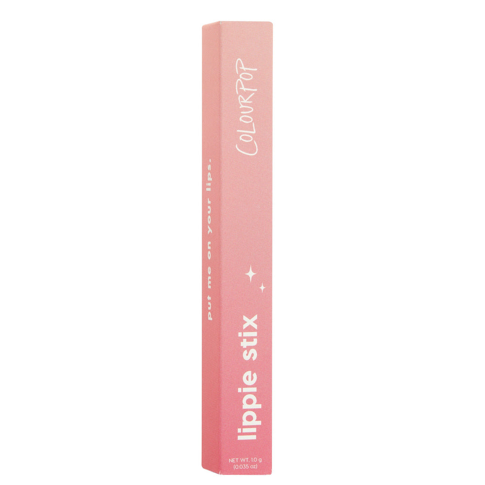 Sassy ColourPop Lippie Stix stands upright in its pink ombré carton, showing white COLOURPOP and lippie stix text with small sparkle icons and net wt 1.0 g (0.035 oz), set against a clean white studio background.