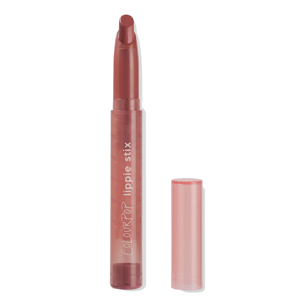 ColourPop Lippie Stix Toasty stands uncapped, revealing a slanted rosy-brown bullet, with the translucent pink cap set to the right on a white background.