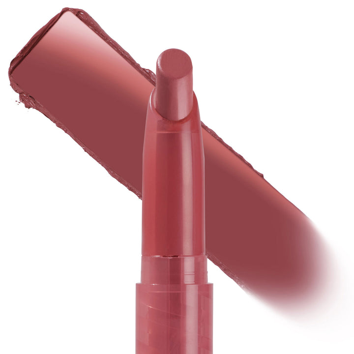 ColourPop Lippie Stix in shade Happy Thoughts stands upright with the rounded bullet exposed, a rosy mauve swatch streaked diagonally behind it on a white background, highlighting the creamy lip color in a slim twist-up tube.