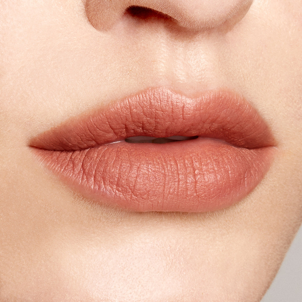 Lips wearing BFF ColourPop Lippie Pencil, lined and softly filled in a warm nude peach with a natural matte finish, shown in a close-up lip swatch on fair skin, highlighting precise definition and smooth texture.