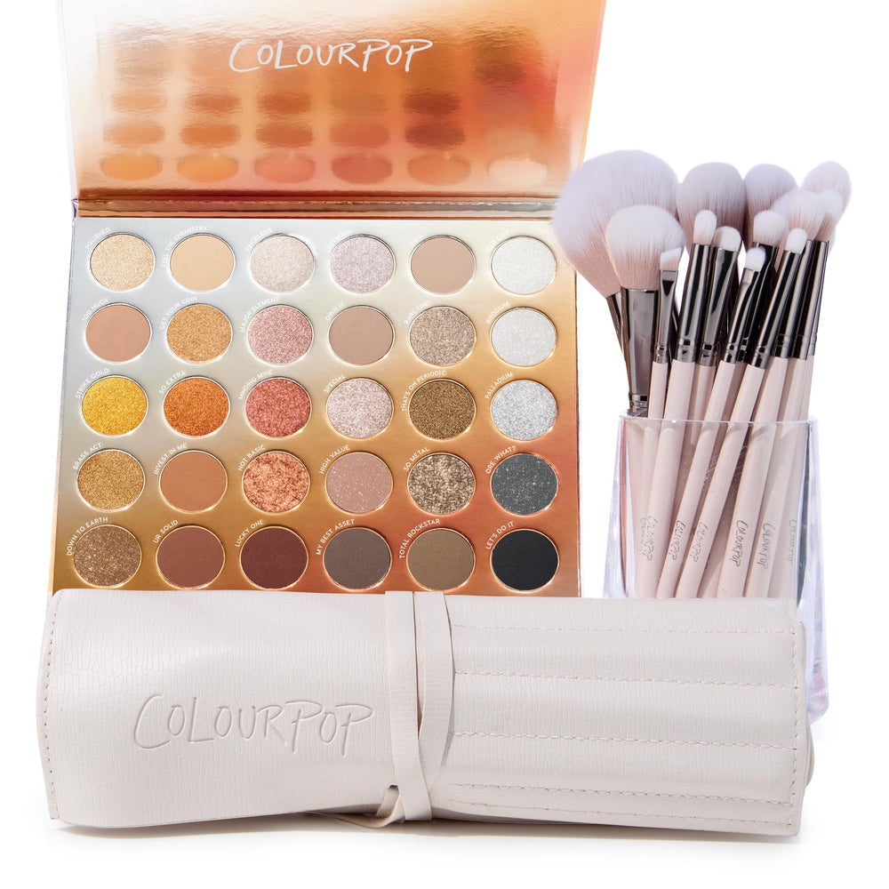 Metallic Mood ColourPop Shadow Palette & Brush Set showcasing a 30-pan warm-to-cool mix of matte and metallic neutrals - golds, coppers, silvers - with soft pink-handle brushes in a clear cup beside a cream ColourPop brush roll on a white background.