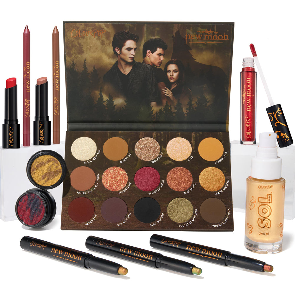 ColourPop Full Collection Set Twilight New Moon bundle showcases an open 15‑pan eyeshadow palette with forest cover art, two Super Shock shadows, three shadow sticks, lip pencils, lippie stix, red gloss, and SOL glow oil on a white backdrop.