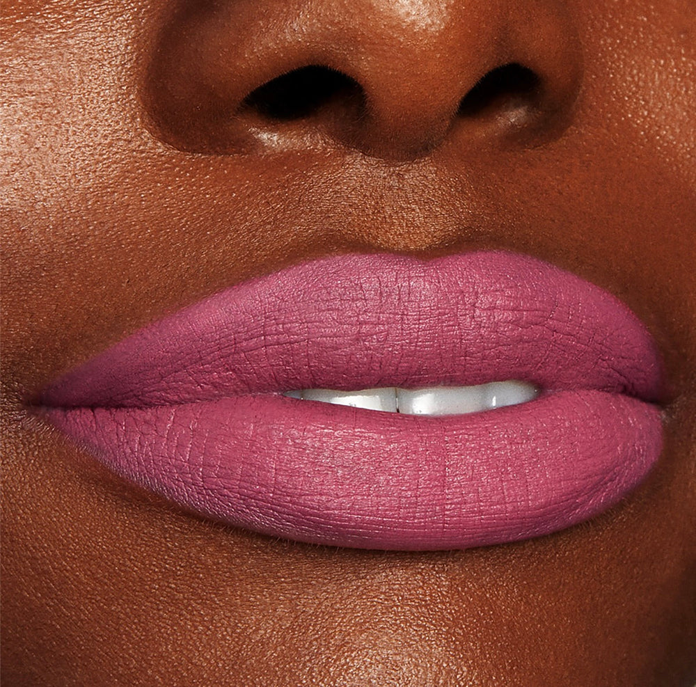 Byron Babe ColourPop Lippie Stix coating lips in a matte mauve‑pink, delivering full‑coverage color with a soft‑focus finish, shown in a close-up beauty shot highlighting smooth texture and precise edges.