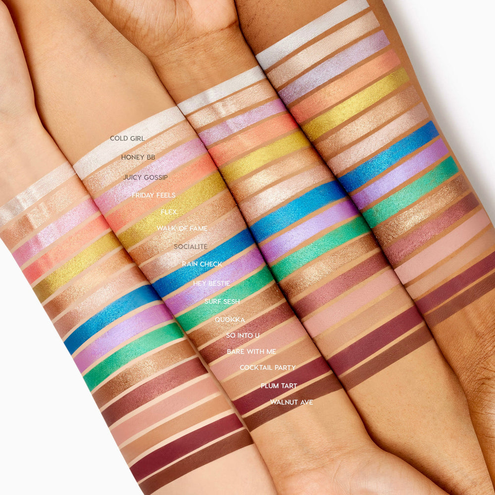 Plum Tart ColourPop Shadow Stix swatch streaked on four forearms, a rich matte plum band labeled “Plum Tart” among rows of shade swatches, showing pigment and finish across multiple skin tones.