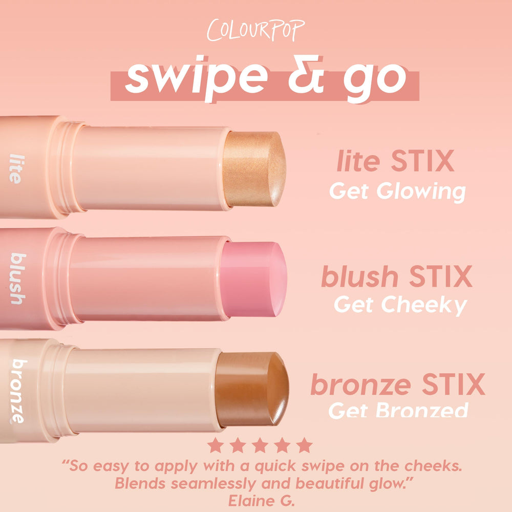 ColourPop Lite Stix in Sunlight shown uncapped and twisted up, a champagne-gold cream highlighter in a soft peach tube, ready to swipe on; displayed beside blush and bronze stix on a pink gradient background.
