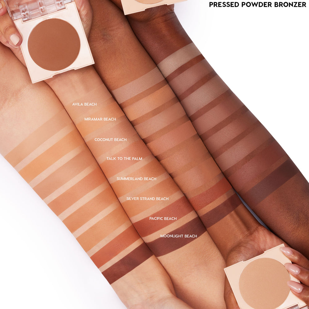 ColourPop Pressed Powder Bronzer in Silver Strand Beach swatched in clean stripes on four arms, with labeled shade lineup and two open round compacts, showing color comparison across skin tones on a white studio background.