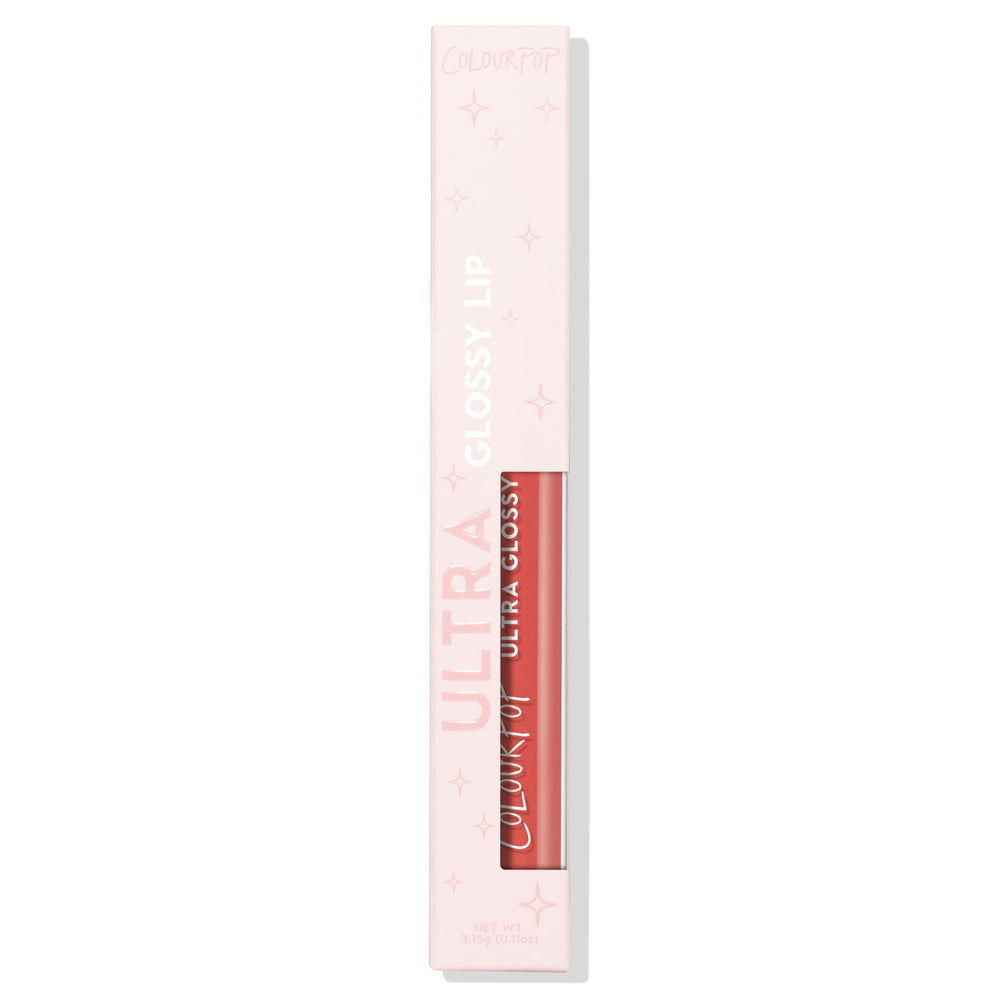 ColourPop Ultra Glossy Lip in Ditto crème, a warm peachy‑pink gloss, displayed in a clear tube within a pale pink box with star accents and ULTRA GLOSSY LIP lettering, delivering a high‑shine, non‑sticky finish.