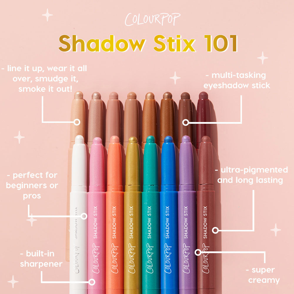 ColourPop Cocktail Party Shadow Stix eyeshadow sticks stand upright with tips exposed, showcasing neutral-to-bright shades from nude, coral, gold, teal, and purple on a pink backdrop, highlighting creamy, long-wear color and a built-in sharpener.