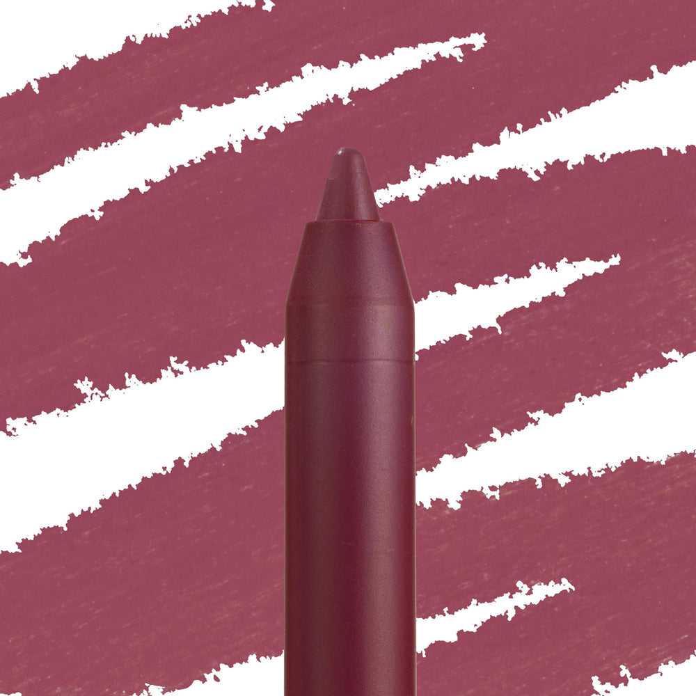 Flattered Lippie Pencil, a ColourPop Lippie Pencil, draws creamy mauve-rose swatches; close-up shows the pointed twist-up tip and matching matte burgundy barrel against a streaked color backdrop, highlighting shade and texture.