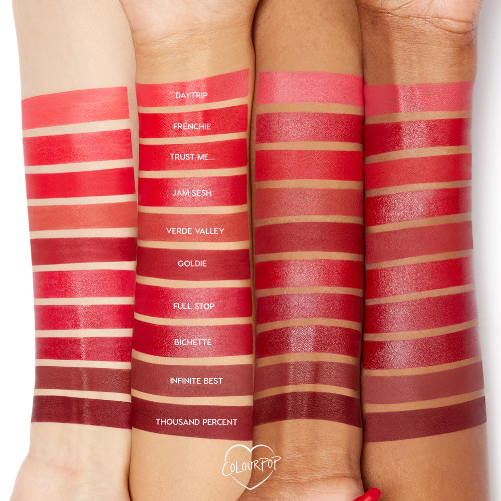 Trust Me Lippie Stix shade swatched on three forearms, positioned between Frenchie and Jam Sesh, with labeled reds from Daytrip to Thousand Percent, showcasing color on light to deep skin in the ColourPop Lippie Stix collection.