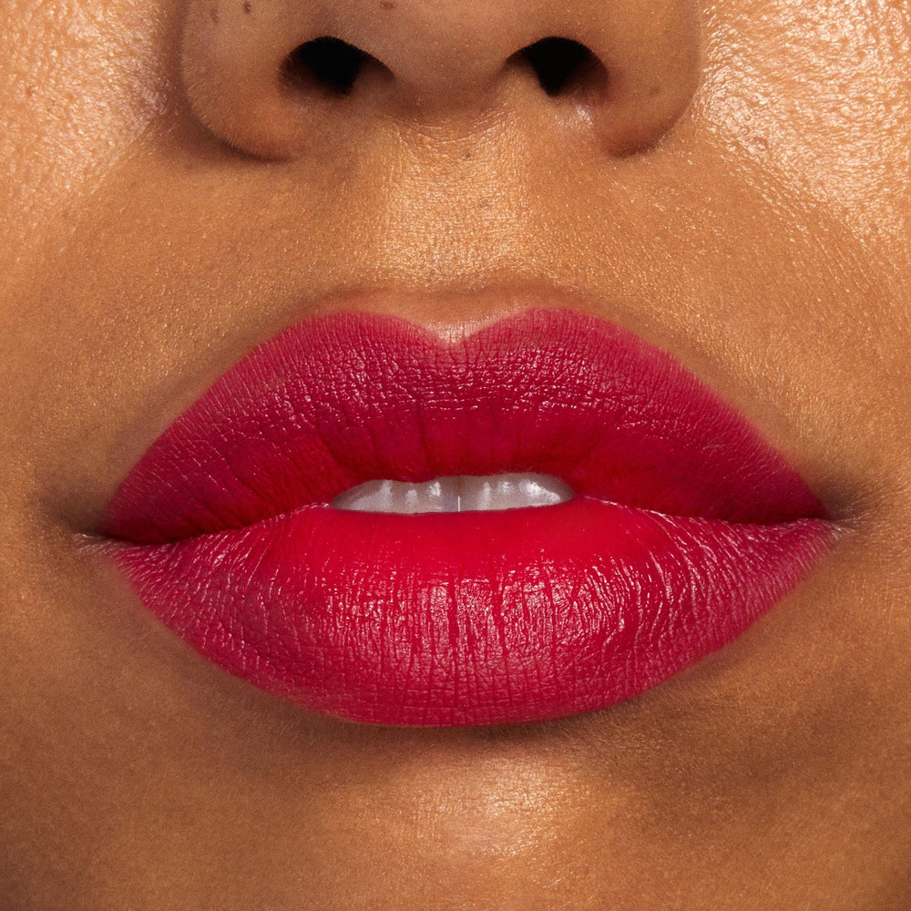 Lips wearing ColourPop Lippie Pencil in I Heart This, lining and filling the mouth with a vibrant fuchsia-red hue for a smooth satin-matte finish; extreme close-up beauty shot showcasing clean edges and rich, long-wearing pigment.