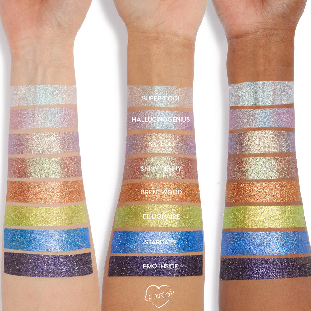 ColourPop Jelly Much Shadow in Super Cool swatched as a wide stripe - an iridescent icy blue‑silver shimmer - on three forearms, with additional shades stacked below to compare color payoff and sparkle across light to deep skin tones.