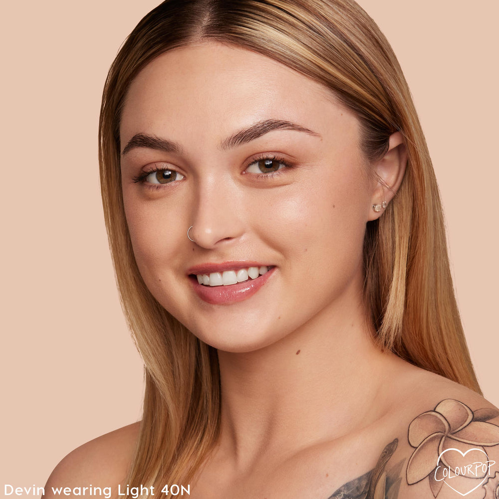 ColourPop Pretty Fresh Creamy Concealer in Light 40 N shown on a model, brightening under-eyes and evening tone with natural, dewy medium coverage; close-up studio shot against a peach backdrop highlights the light neutral shade match.