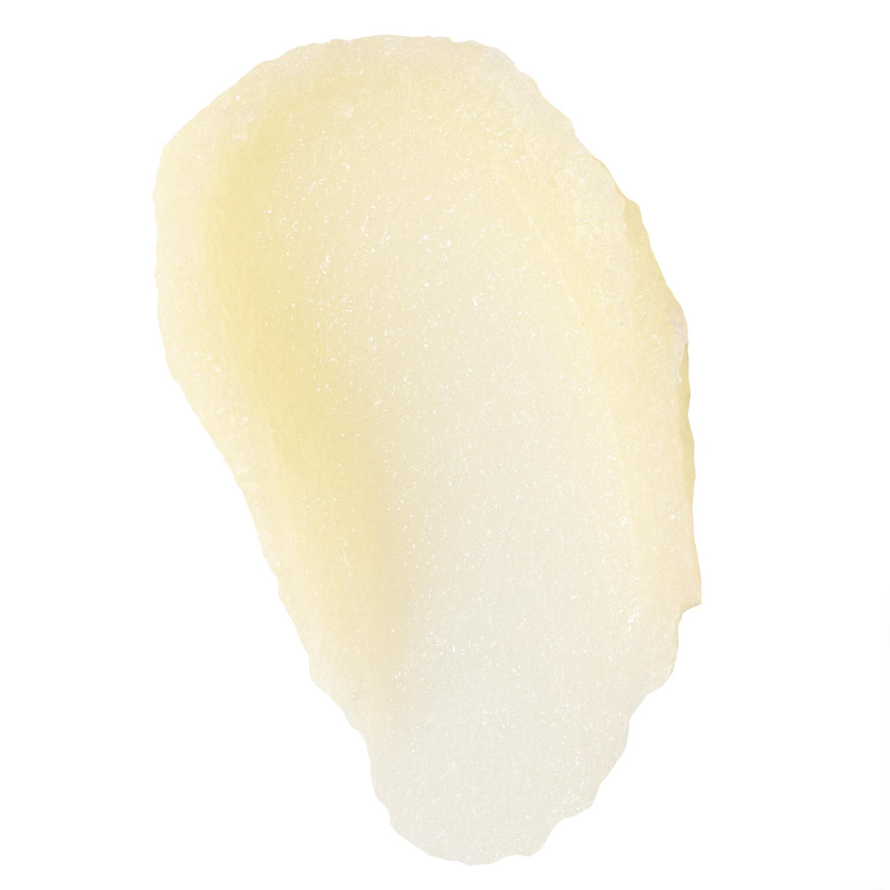 Vanilla Cake lip scrub swatch spreads in a smooth, pale yellow smear with fine sugar crystals and a glossy finish on a white background, showcasing texture and exfoliation; ColourPop Lip Scrub detail for soft, hydrated lips.
