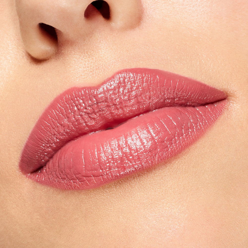 Rosy-pink lips wearing ColourPop Lippie Stix in Felt Cute, displaying a creamy, glossy finish and smooth full coverage in a tight close-up swatch ideal for everyday makeup.