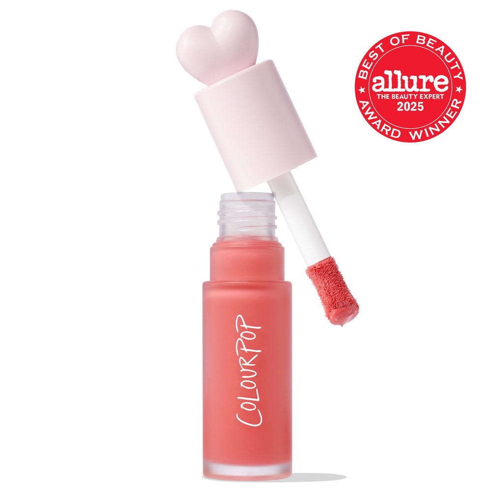 Super Shy ColourPop Liquid Blush with a heart-shaped pink cap, doe-foot applicator lifted showing a bead of peachy-pink pigment, in a frosted tube with vertical COLOURPOP logo and an Allure 2025 Best of Beauty badge on white.