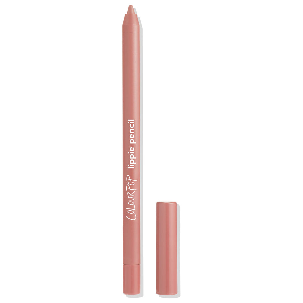 Little One ColourPop Lippie Pencil standing upright with its cap beside it, revealing a sharpened soft rosy nude tip; blush‑pink barrel with white logo on a clean white background, ready for precise lip lining.