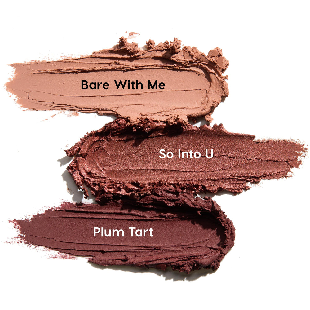 ColourPop Shadow Stix Burgundy Besties swatches show three creamy eyeshadow smears - Bare With Me (soft nude), So Into U (rosy mauve), and Plum Tart (deep burgundy) - streaked horizontally on a white background for shade comparison.