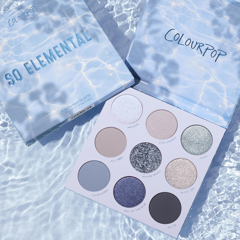 So Elemental ColourPop Shadow Palette displayed open on rippled pool water, revealing nine cool‑toned matte, shimmer, and glitter shades - icy blue, taupe, and silver - beside the water‑print lid and branded box.