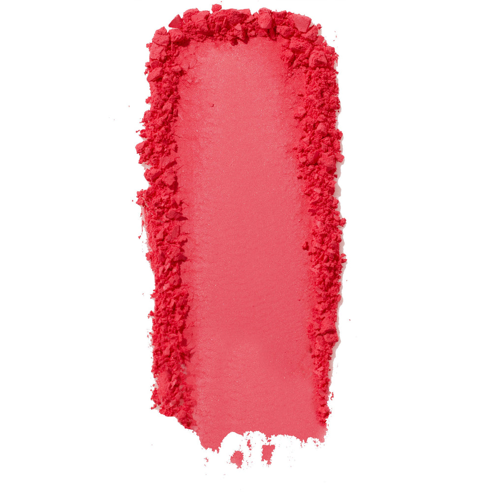 ColourPop Pressed Powder Blush Woo Me swatch - vibrant coral pink pigment swept in a thick vertical streak with a smooth center and crumbled edges, showing buildable payoff and texture on a clean white background.
