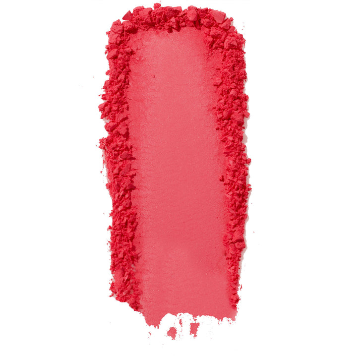 ColourPop Pressed Powder Blush Woo Me swatch - vibrant coral pink pigment swept in a thick vertical streak with a smooth center and crumbled edges, showing buildable payoff and texture on a clean white background.