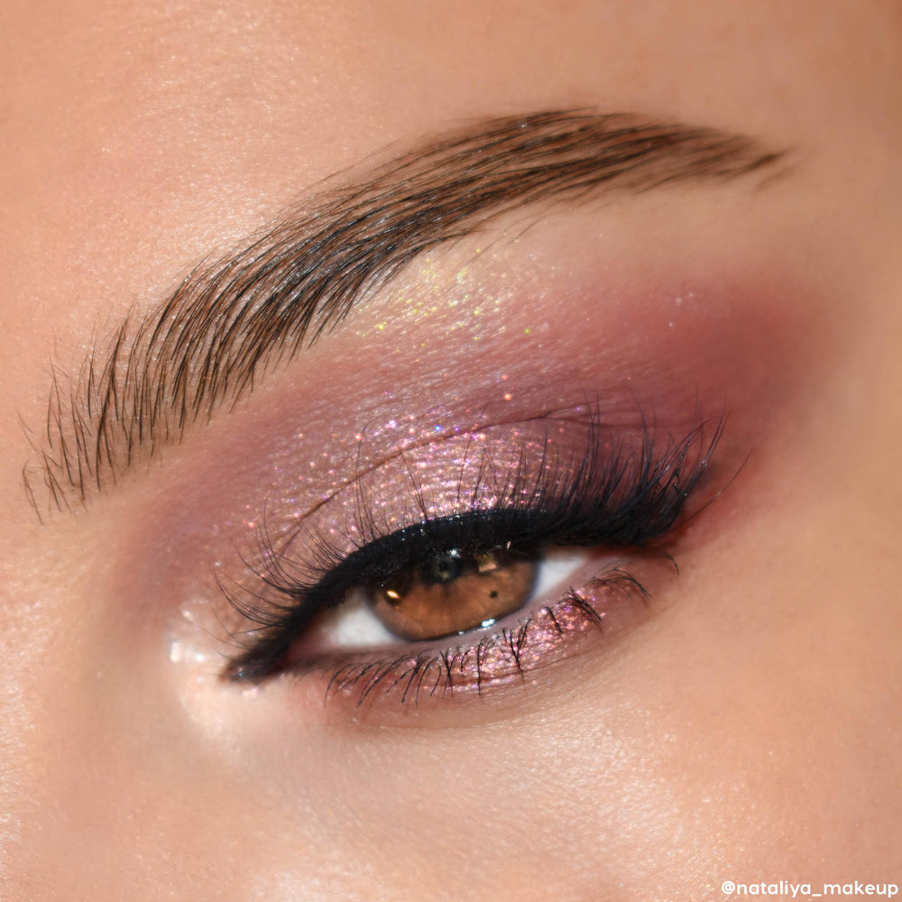 Shimmering eyelid displays mauve-to-rose gold glitter from the After Hours ColourPop Shadow Palette, blended with deep plum at the outer corner and finished with sleek black liner and voluminous lashes in a close-up evening eye look.